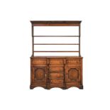 A 19th-century Welsh (probably Anglesey) oak and deal breakfront base dresser and rack, with three