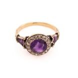 A Victorian amethyst and diamond cluster ring, featuring a round mixed-cut amethyst with intense