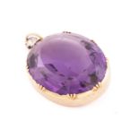 A large amethyst and diamond pendant, featuring an oval mixed-cut amethyst, approximately