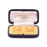 A pair of 18 carat gold cufflinks in an associated Boucheron cufflink box. the rectangular cut-