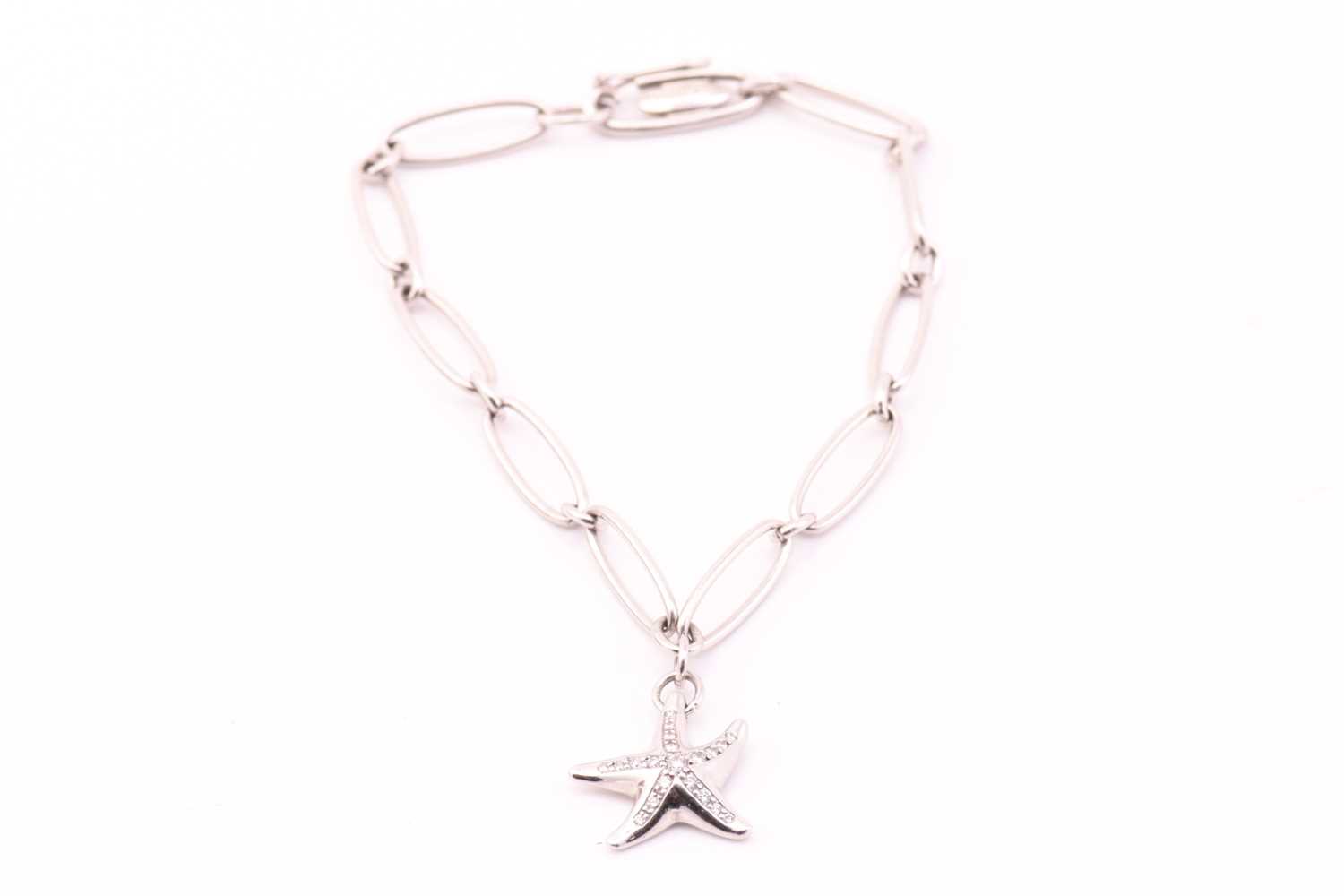 Tiffany & Co. - A platinum charm bracelet with diamonds, comprises a figural starfish charm,