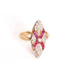 A gem-set navette ring, comprises multiple calibré-cut rubies and red pastes in a cruciform, table-