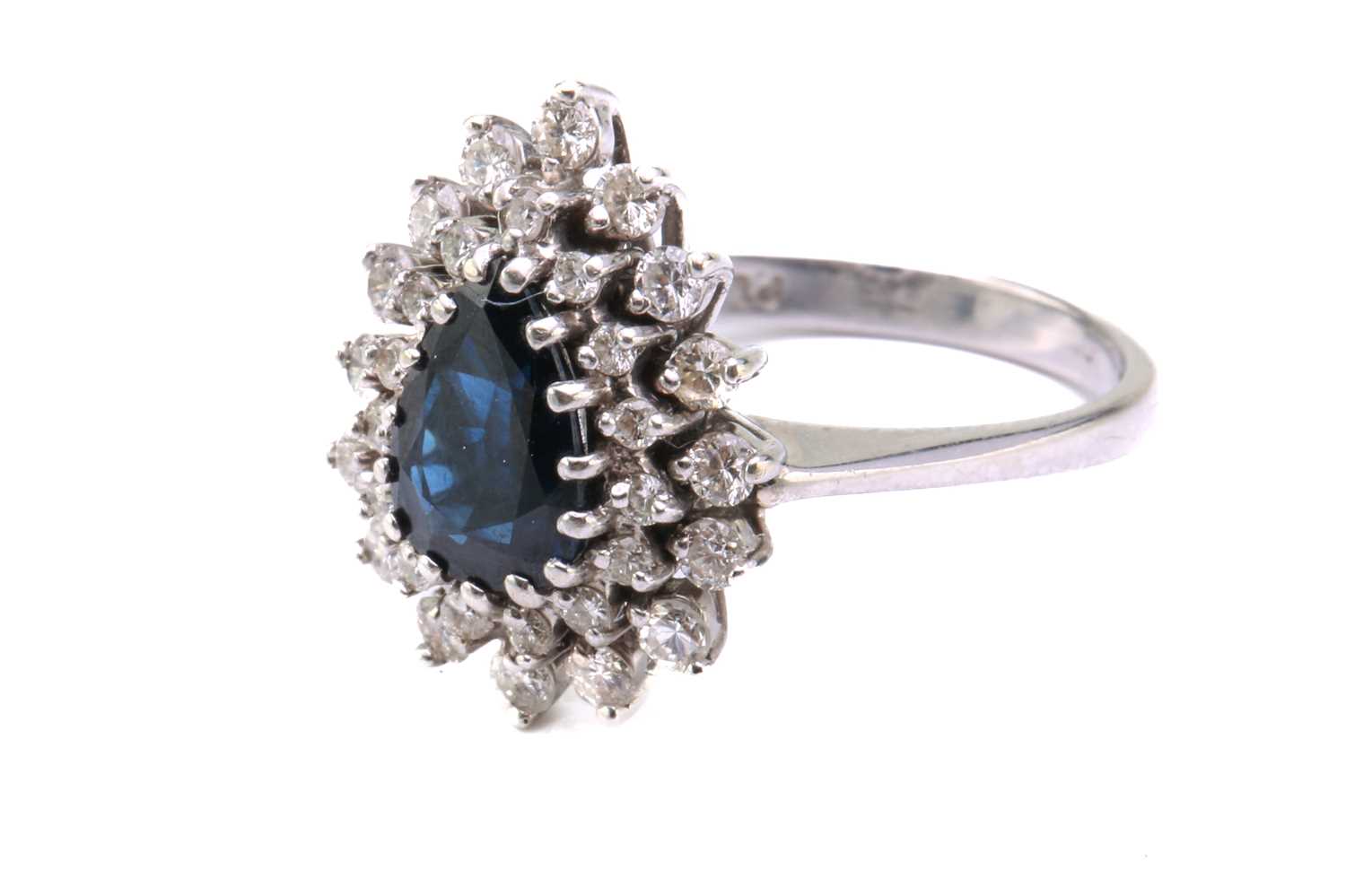 A sapphire and diamond entourage ring, featuring a pear-shaped sapphire in dark blue colour, - Image 3 of 4