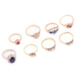 Eight assorted gem-set ring, including An 18ct gold three-stone bypass ring, London hallmarked,