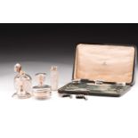 A collection of silver comprising of a manicure set in a fitted case, pair of dwarf candlesticks