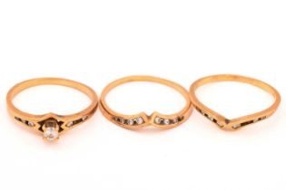 A three-piece diamond ring set in 18ct gold, consisting of a diamond solitaire ring in a high-