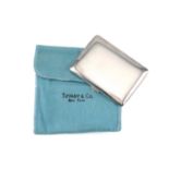A Tiffany & Co. silver powder compact, rectangular plain body with rounded corners, push-button