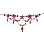 A garnet and red paste garland necklace in gilt metal, with florets, five-pointed stars and teardrop