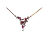 A diamond and ruby necklace, with four round faceted rubies and diamond accents interspersing on