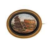 A Grand Tour micromosaic brooch, depicting scenery from the Colosseum in Rome, set on an oval