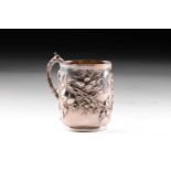An Edwardian silver christening mug, decorated with repousse apple tree motifs chased throughout