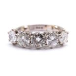 A five-stone diamond ring in platinum, composed of five round brilliant diamonds mounted in a six-