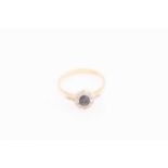 A sapphire and diamond halo ring, comprises a strongly dichroic sapphire in oval-cut, encircled in a