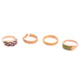 A 22ct gold wedding band and three other rings; The wedding band has a plain court-profile shank,