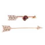 A garnet and diamond arrow bar brooch, and another arrow jabot brooch; the bar brooch in the form of