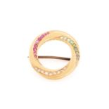 A gem-set whirlpool brooch, comprises swirls of rose-cut diamonds, faceted rubies, emeralds as