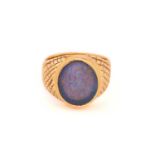 A black opal signet ring, featuring an oval precious opal panel, translucent body with a dark