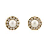 A pair of pearl and diamond earrings in 18ct gold, each consisting of a 7.0 mm round pearl, set