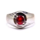 A signet ring set with synthetic ruby, comprises an oval-cut ruby of 5.7 x 4.9 mm claw set on the