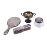 A silver part dressing table set with a cut glass powder box with a silver cover, a clothes brush,