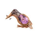 A gem-set kingfisher brooch in 9ct gold, wirework in the form of a kingfisher, with a garnet eye and