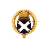 An enamel heraldic brooch, displaying an engraved castle on top of a French-style escutcheon with