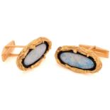 A pair of Modernist opal cufflinks, each comprises a long oval Australian opal inlay, bordered by an