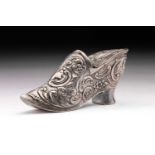 A 19th century novelty silver snuff box; in the form of a lady's shoe. Highly decorated with