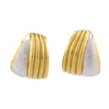 A pair of two-toned clip post earrings, each composed of a curved panel with fluted details,
