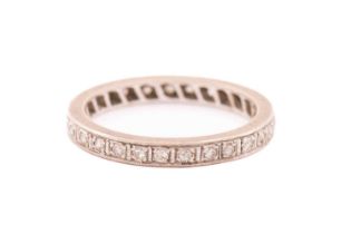 A diamond eternity ring, fully pavé-set with round single-cut diamonds, each approximately