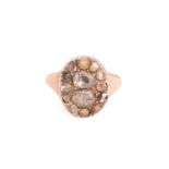 A diamond-set panel ring, with an oval face fully pavé-set with differently sized rose-cut diamonds,