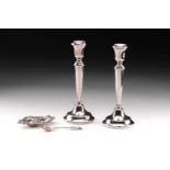A pair of silver candlesticks of plan form with round domed loaded bases, 26cm high, Birmingham