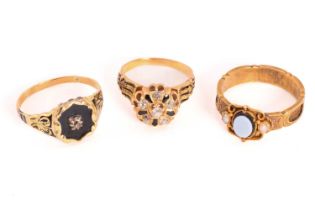 Three 19th-century mourning rings; including a signet ring with a hexagonal onyx ring face with an