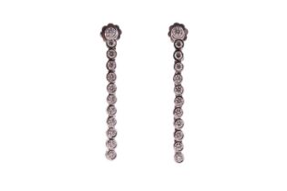 A pair of diamond line drop earrings, each has a dangling enhancing part detachable from the