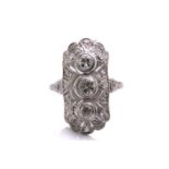 An Art Deco diamond panel ring, composed of three old-European cut diamonds, trails vertically on an