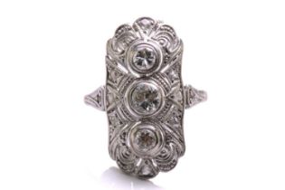 An Art Deco diamond panel ring, composed of three old-European cut diamonds, trails vertically on an