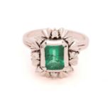 A synthetic emerald cocktail ring, centred with a step-cut synthetic emerald set in collet,
