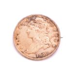 An 1836 United States Dollar Eagle coin, converted into a brooch with a pin back in white metal. The