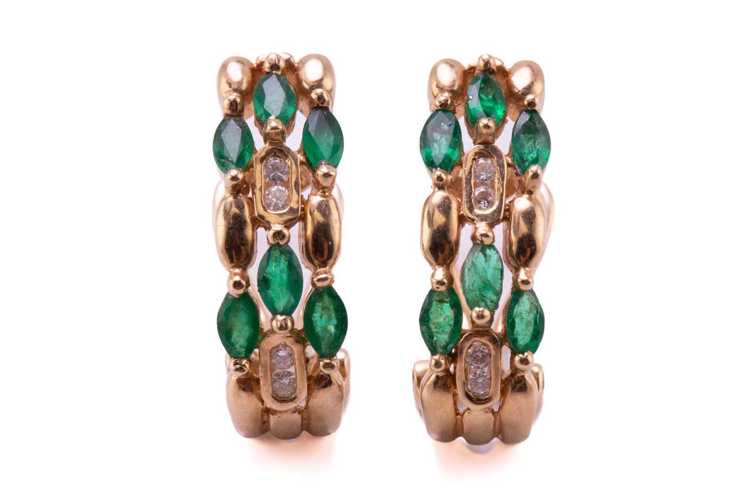 A pair of emerald and diamond earrings, each comprises six marquise-shaped emeralds and four