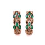 A pair of emerald and diamond earrings, each comprises six marquise-shaped emeralds and four