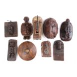 A collection of West African figural house panels and mask plaques, to include a hand held Songye