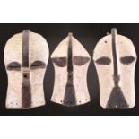 Three Luba Bilume kifwebe, Democratic Republic of Congo, each with crest and linear incised