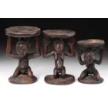 A Luba double caryatid stool, Democratic Republic of Congo, carved as a standing male and female,