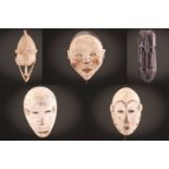 A Senufo double mask, Ivory Coast, 42cm; a weathered Bambara mask, 32.5cm; a Lega Bwami mask,