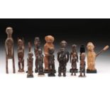 A collection of fifteen principally Lobi standing figures, Burkina Faso, some with traces of