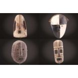 Four Kusu Nsembu masks, Democratic Republic of Congo, each painted in coloured pigments, 28cm -