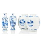 A pair of Chinese blue & white barrel shape vases, with round panels depicting boys at play, against