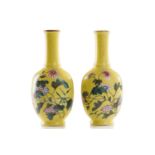 A pair of small Chinese yellow ground vases, decorated with flowering blooms and butterflies, four-