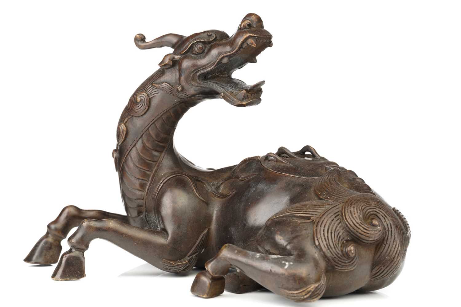 A Chinese bronze figure of a recumbent Pixiu, its snarling head turned over its shoulder, the lid