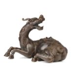 A Chinese bronze figure of a recumbent Pixiu, its snarling head turned over its shoulder, the lid